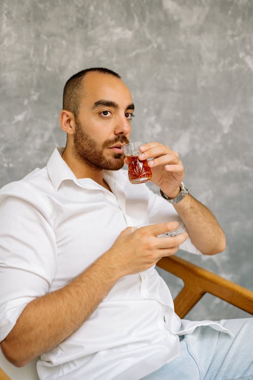 A Bearded Man Holding a Clear Drinking Glass