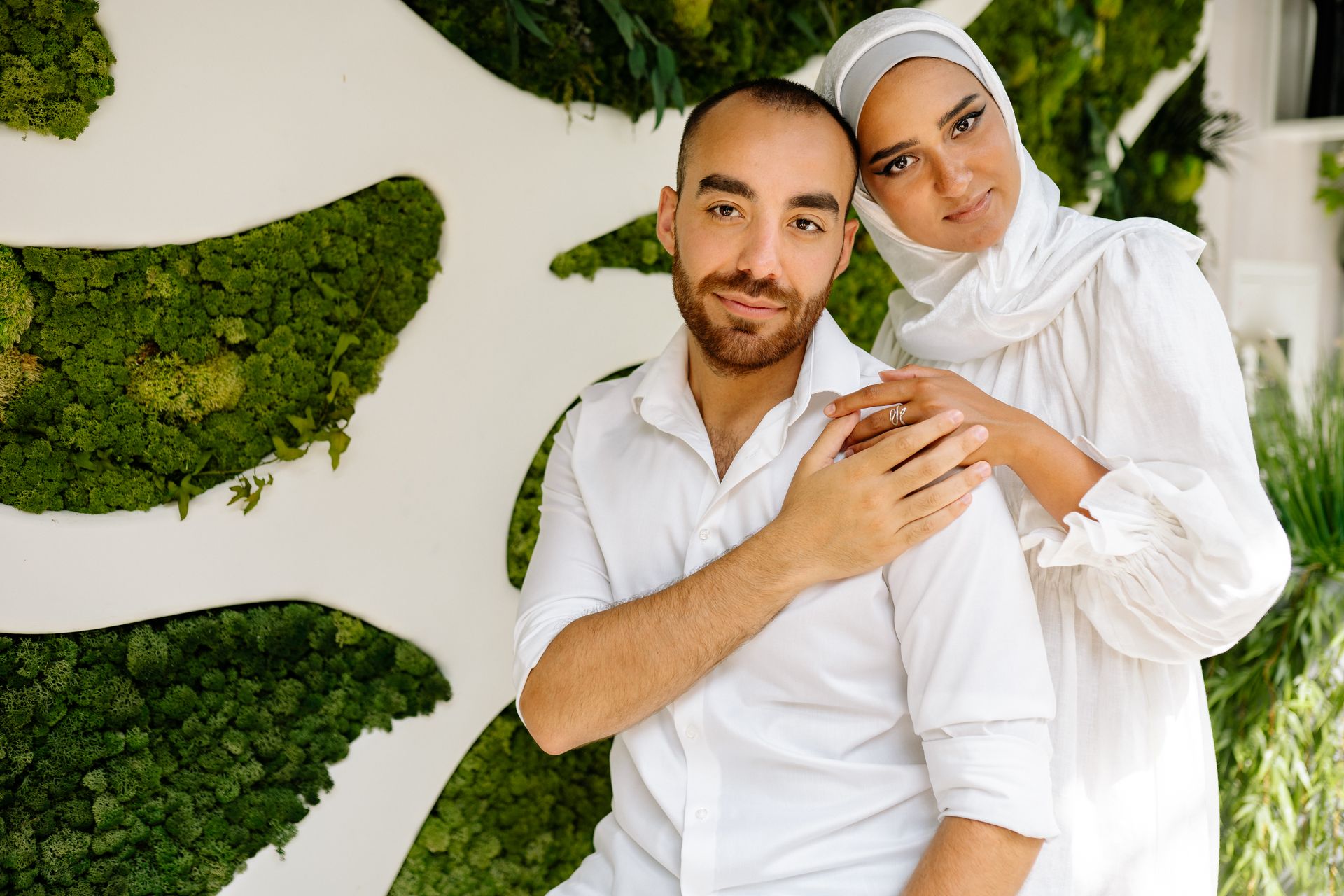 A Couple Standing Near a Vertical Garden