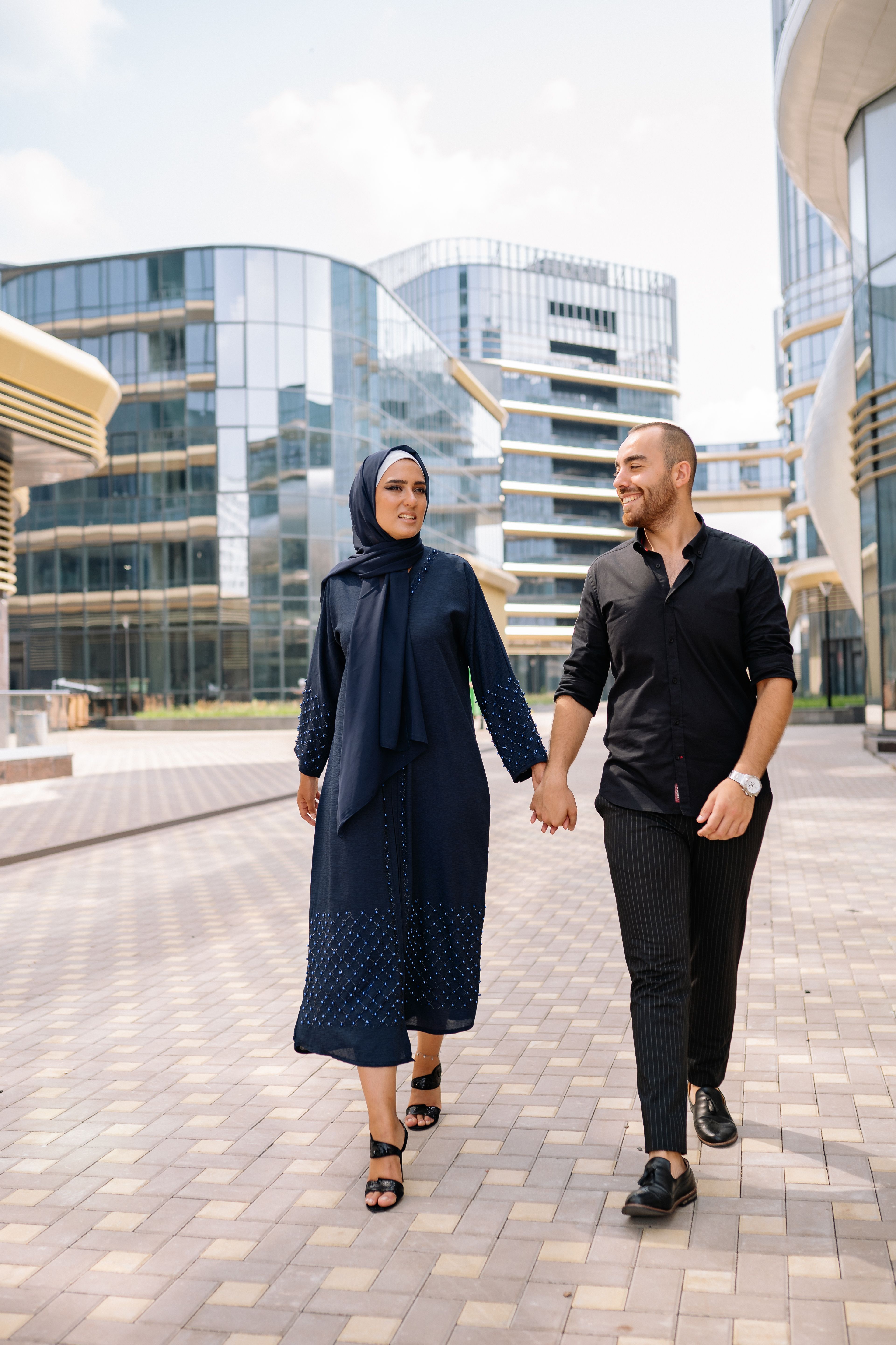 A Couple Walking on Pavement Holding Hands · Free Stock Photo