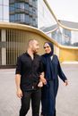 Man in Black Button Up Shirt Standing Beside Woman in Black Hijab