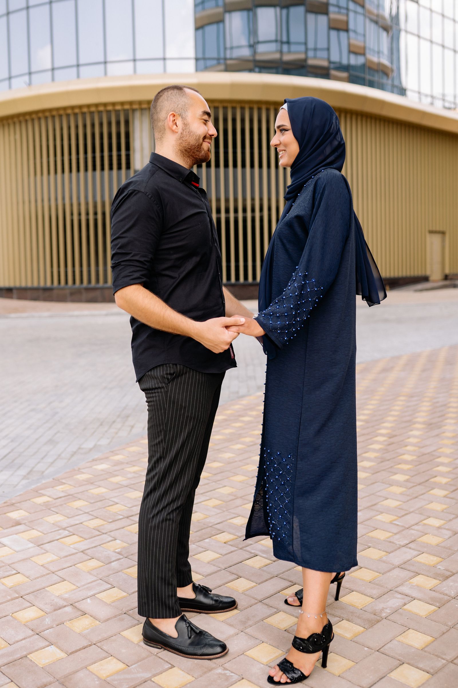 A Muslim couple holding hands outdoors