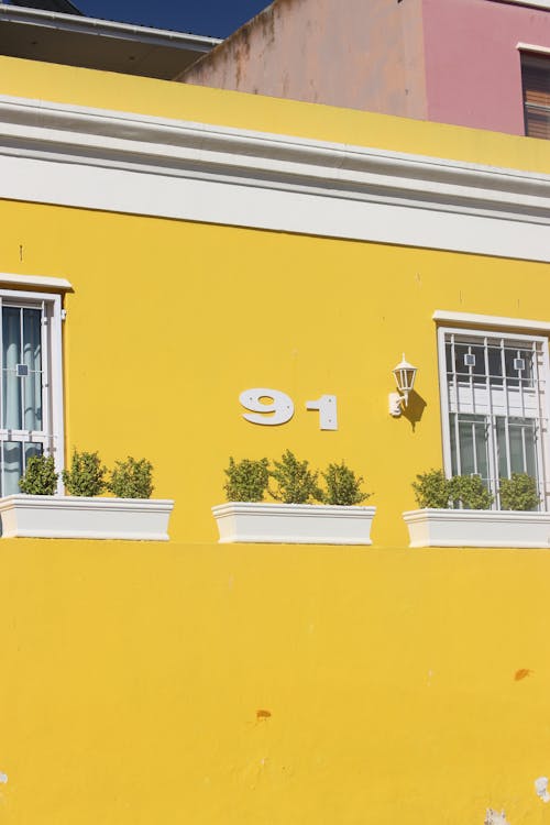 Yellow Painted House With White Window Frame