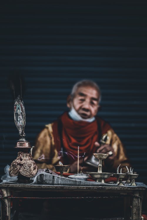 Elderly Man Selling Antiques on Market