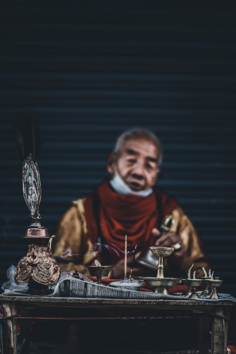 Elderly Man Selling Antiques On Market