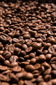 High-resolution close-up of aromatic roasted coffee beans with natural lighting.