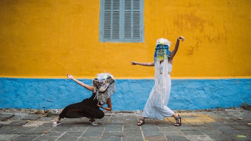 Women in Festival Masks Dancing on the Street