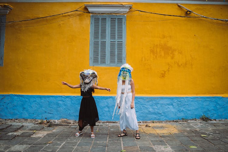 Girls Wearing Colorful Festival Masks 