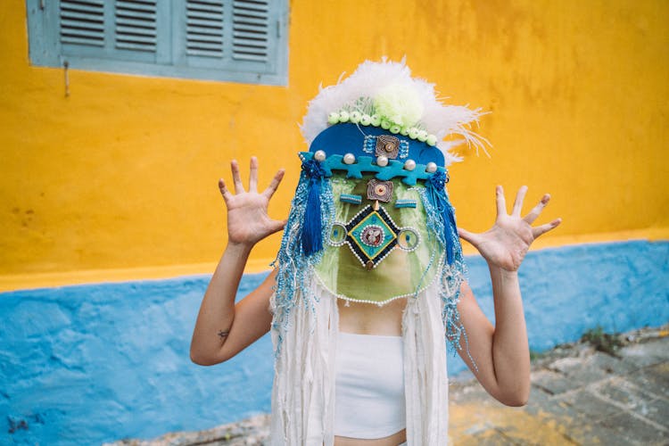 A Woman Wearing A Festival Mask