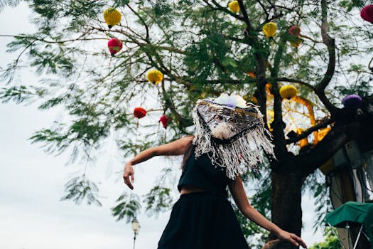 A dancer in traditional costume performs under colorful lanterns at a festival in Taiwan.