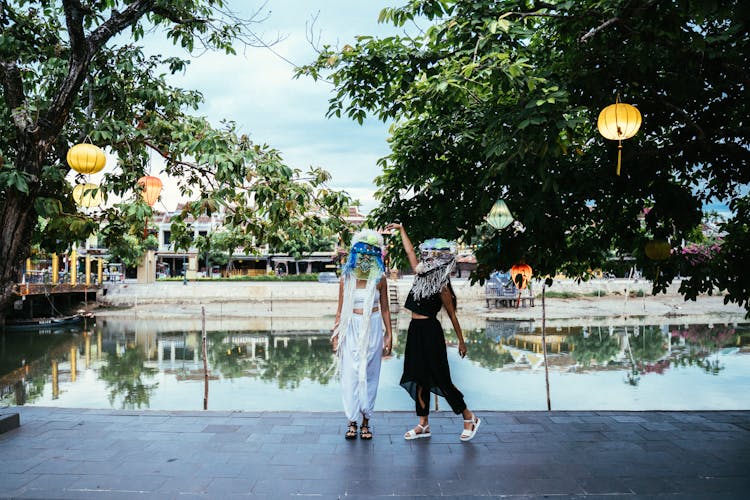 Women In Festival Masks Standing Near The River