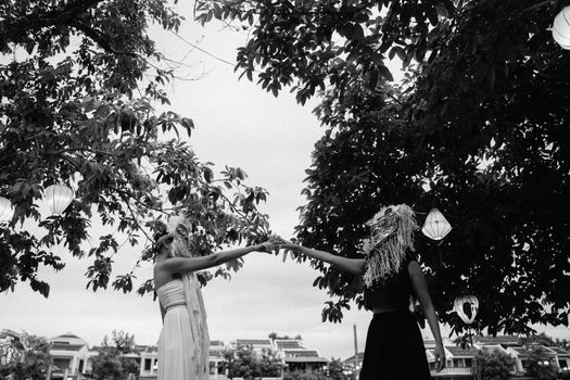 Grayscale Photo of Woman in Dress Holding Tree Branch
