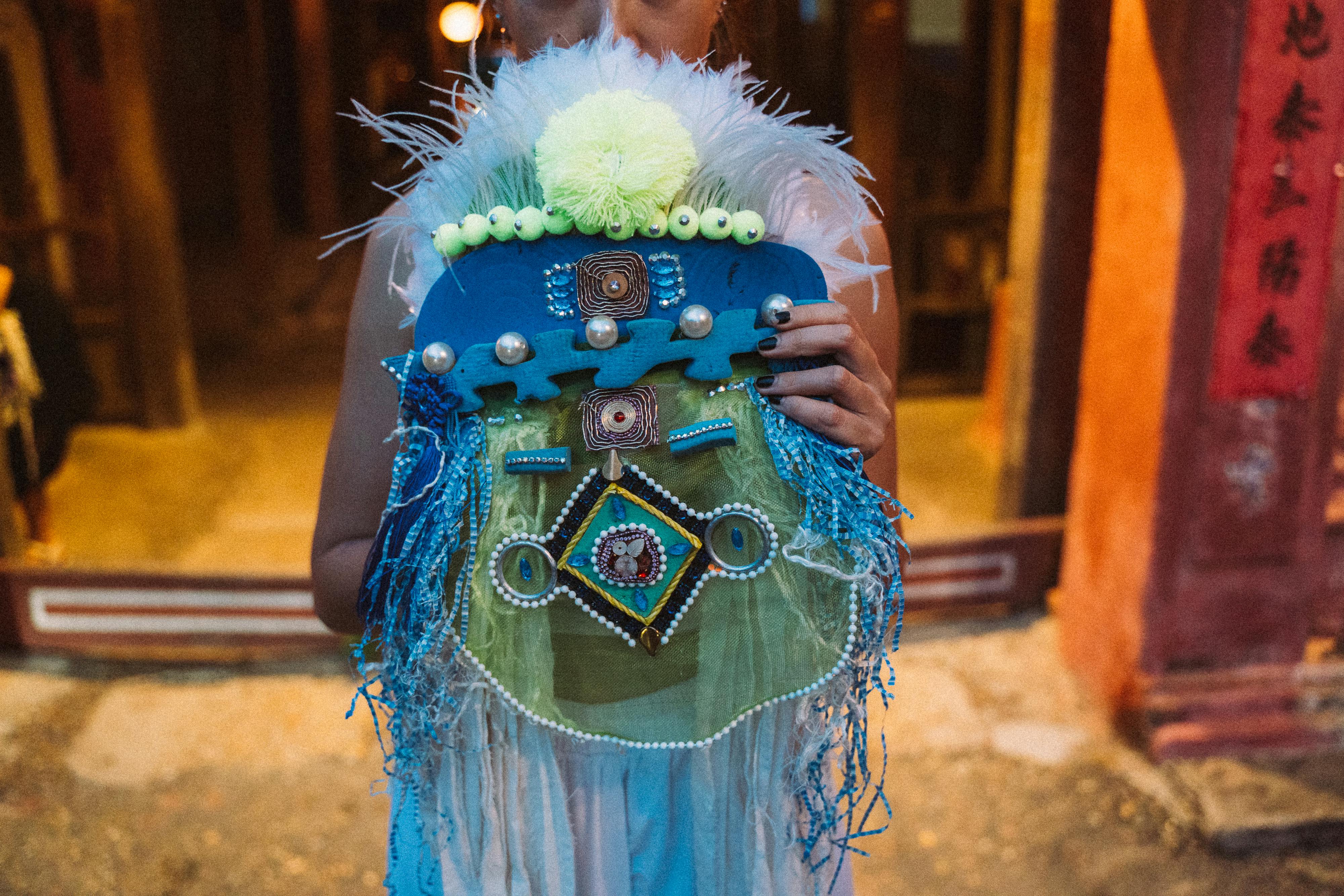 Close up of Woman Holding Decorated Mask