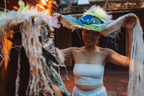 Woman in White Tube Top Wearing Blue and White Mask