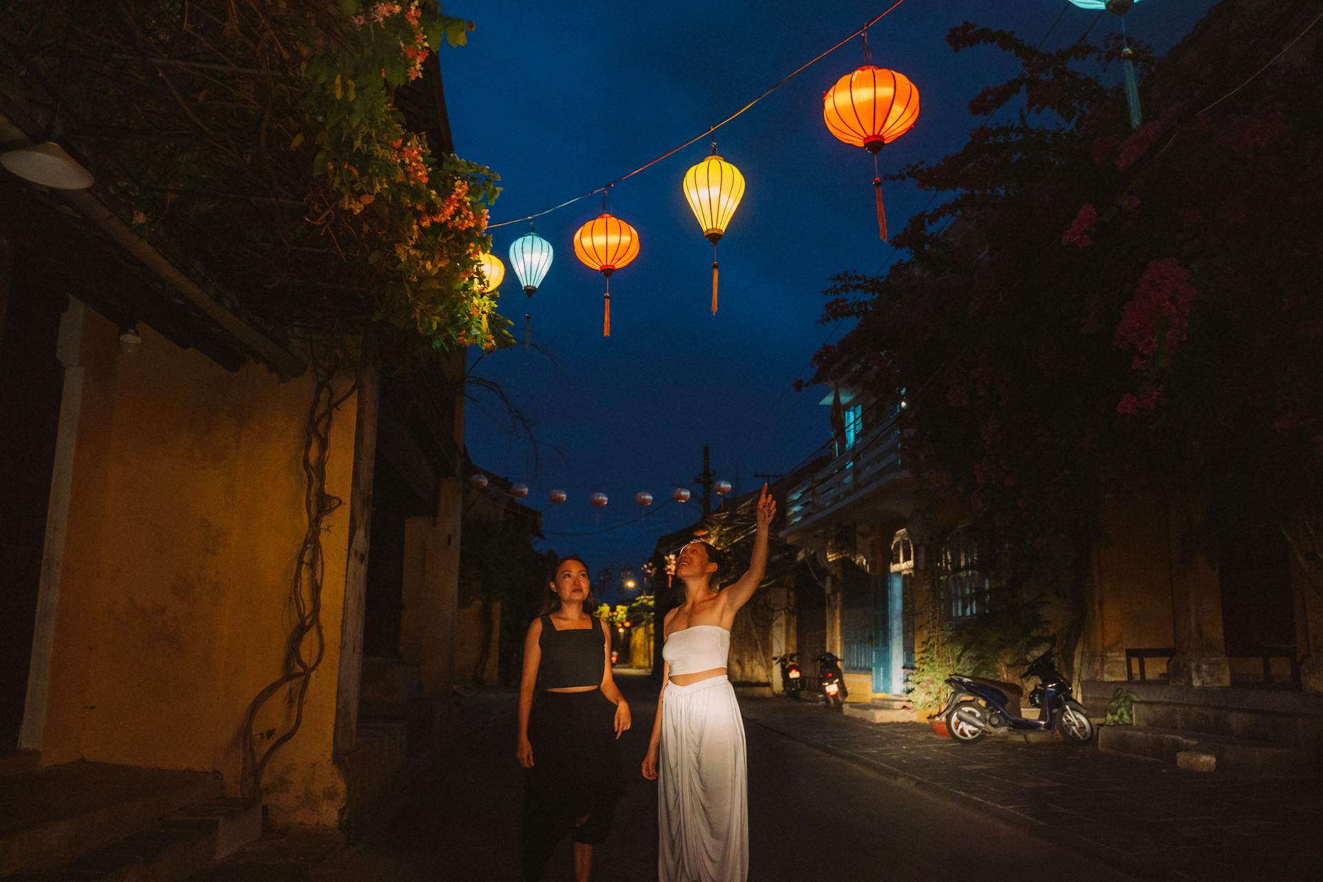 Women Pointing at Paper Lanterns in the Street