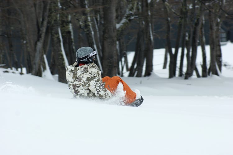 Person Riding On A Sled In Winter