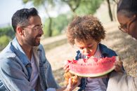 Man in Black Leather Jacket Holding Watermelon
