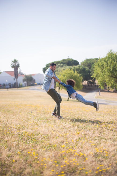 Free Father and Son Playing on the Grass Stock Photo