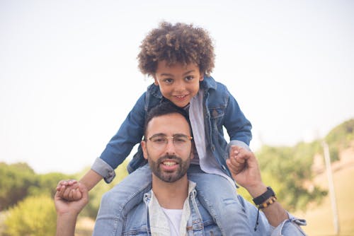 Free Father Carrying His Son on His Shoulders Stock Photo