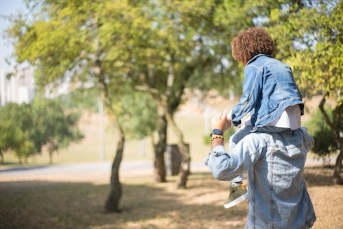 Free Father Carrying His Son on His Shoulders Stock Photo