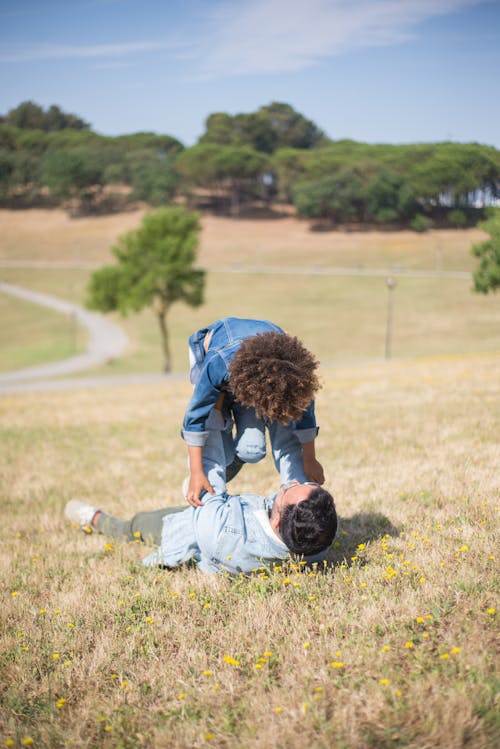 Free Father and Son Playing on Grass at Park Stock Photo