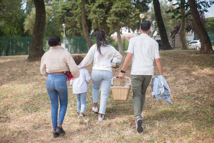 A Family Walking In The Park