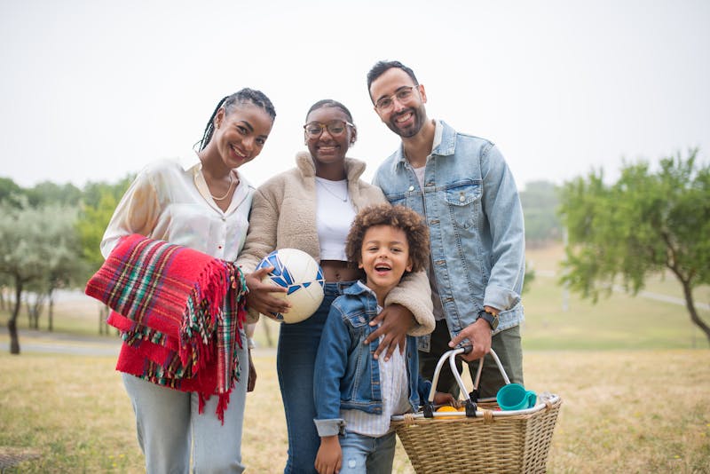 A joyful family enjoying a picnic together outdoors in Portugal's lush scenery.