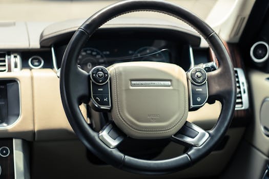 Detailed shot of a luxury car steering wheel, showcasing sophisticated design.