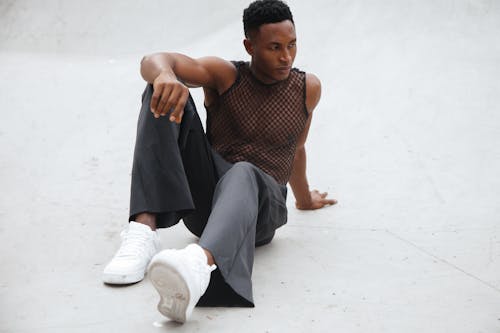 Man Wearing White Shoes while Posing on White Surface