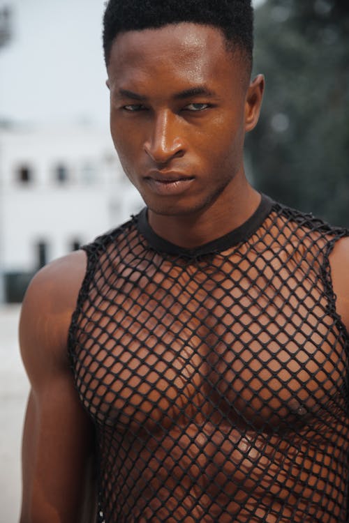 A Man in Black Mesh Tank Top Looking with a Serious Face