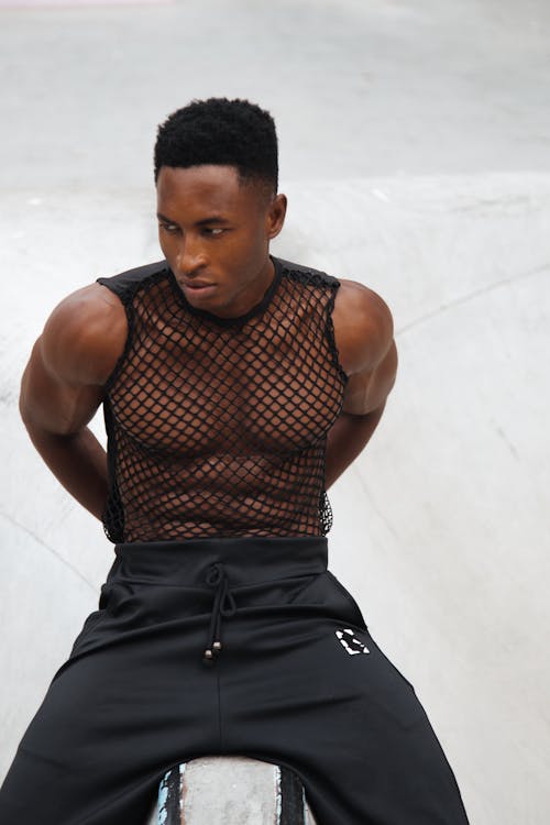 Stylish Man in Mesh Top and Black Pants