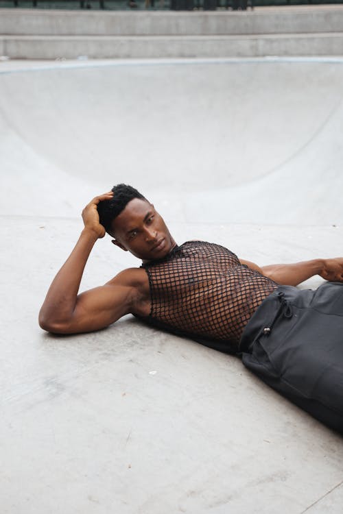 Man Posing on the Floor with his Hand on his Hair