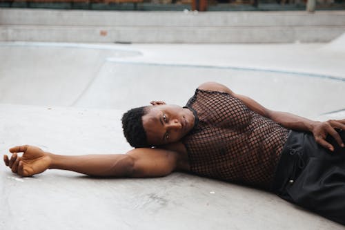 Man Lying on the Floor Posing with his Hand Raised