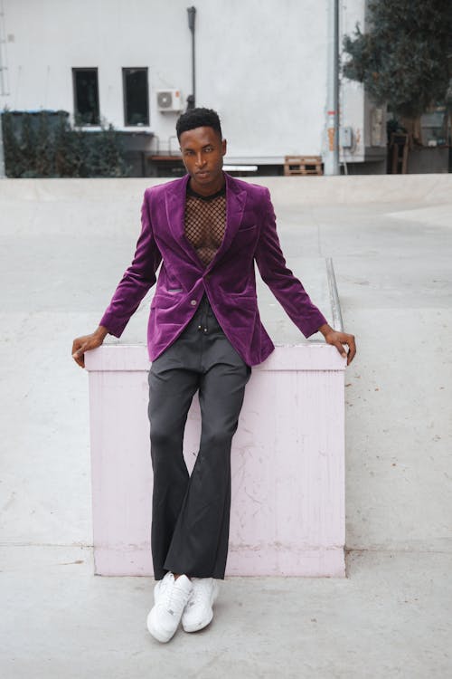 Free A Man in Purple Suit and Gray Pants Standing on the Street Stock Photo