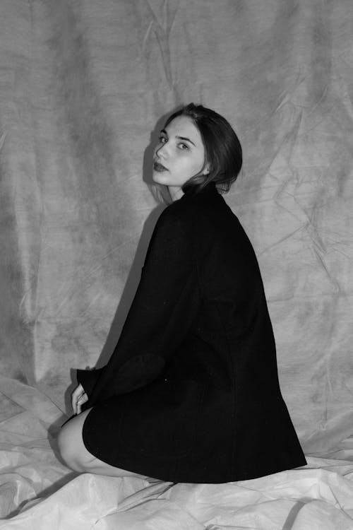 Grayscale Photo of a Beautiful Woman Wearing Black Coat