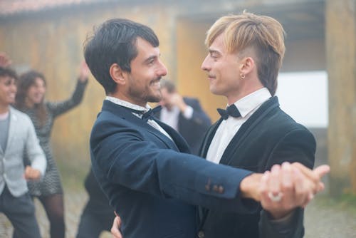 Free Men Looking at Each Other While Dancing Stock Photo