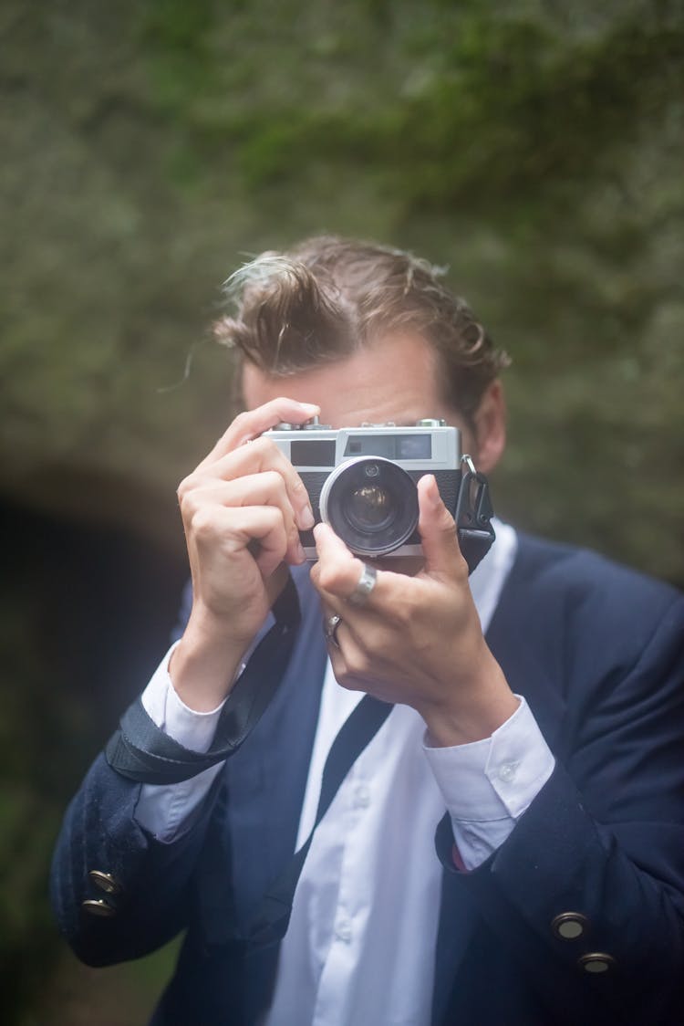 Man In Blue Blazer Using An Analog Camera 