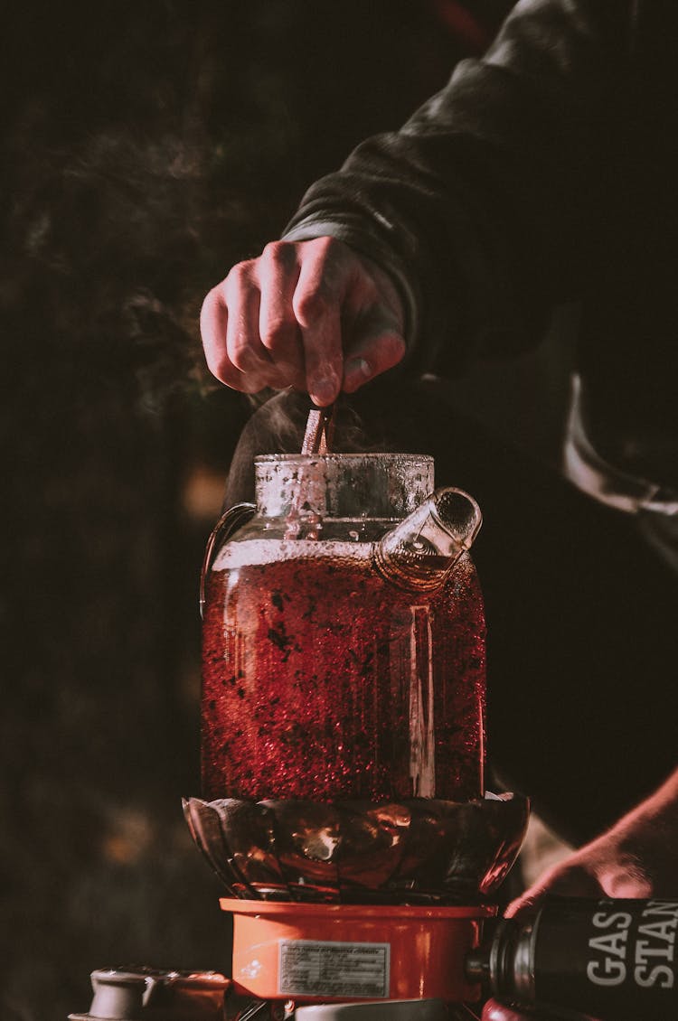 Man Stir Tea In Jug