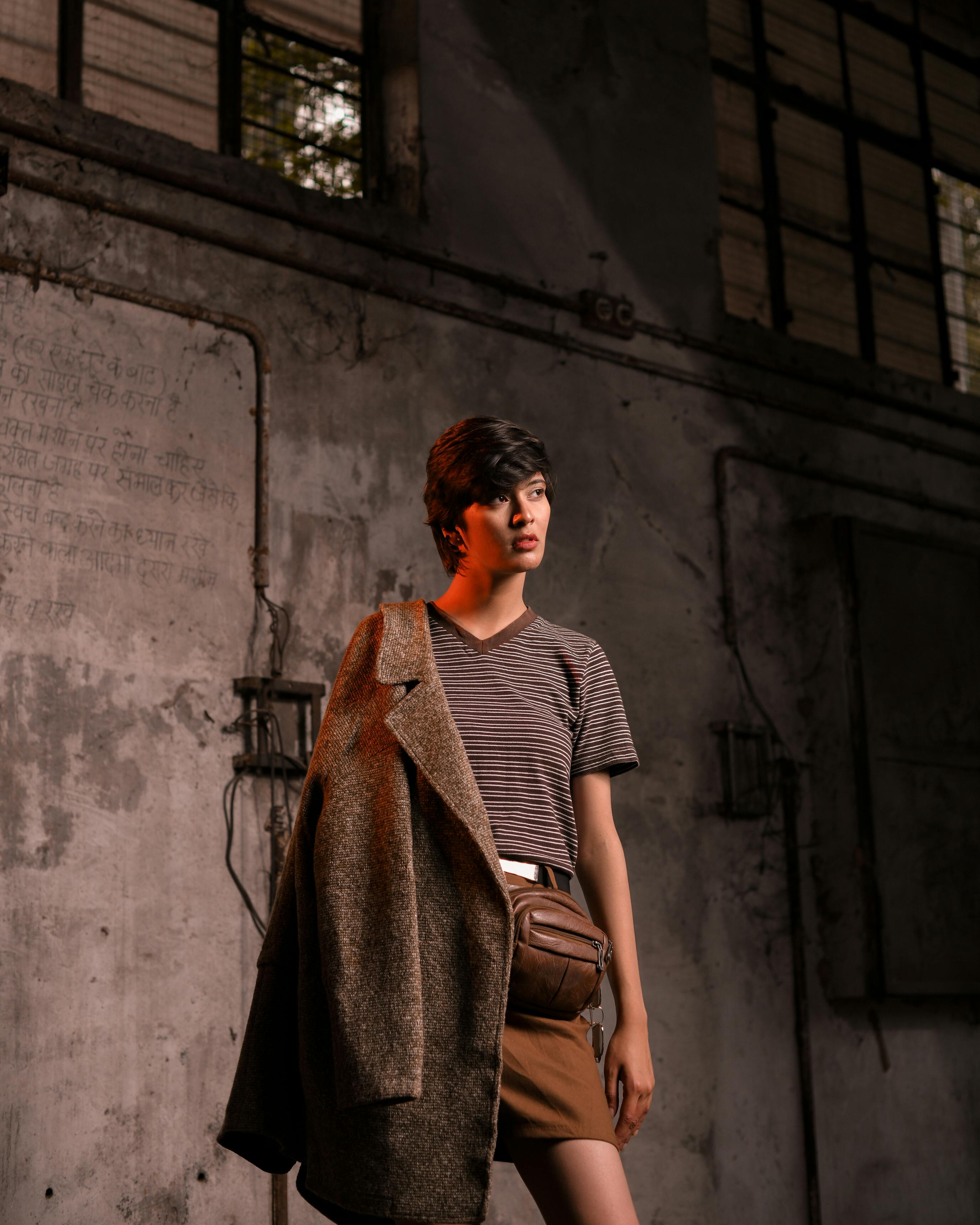 woman in stylish clothes posing in abandoned building