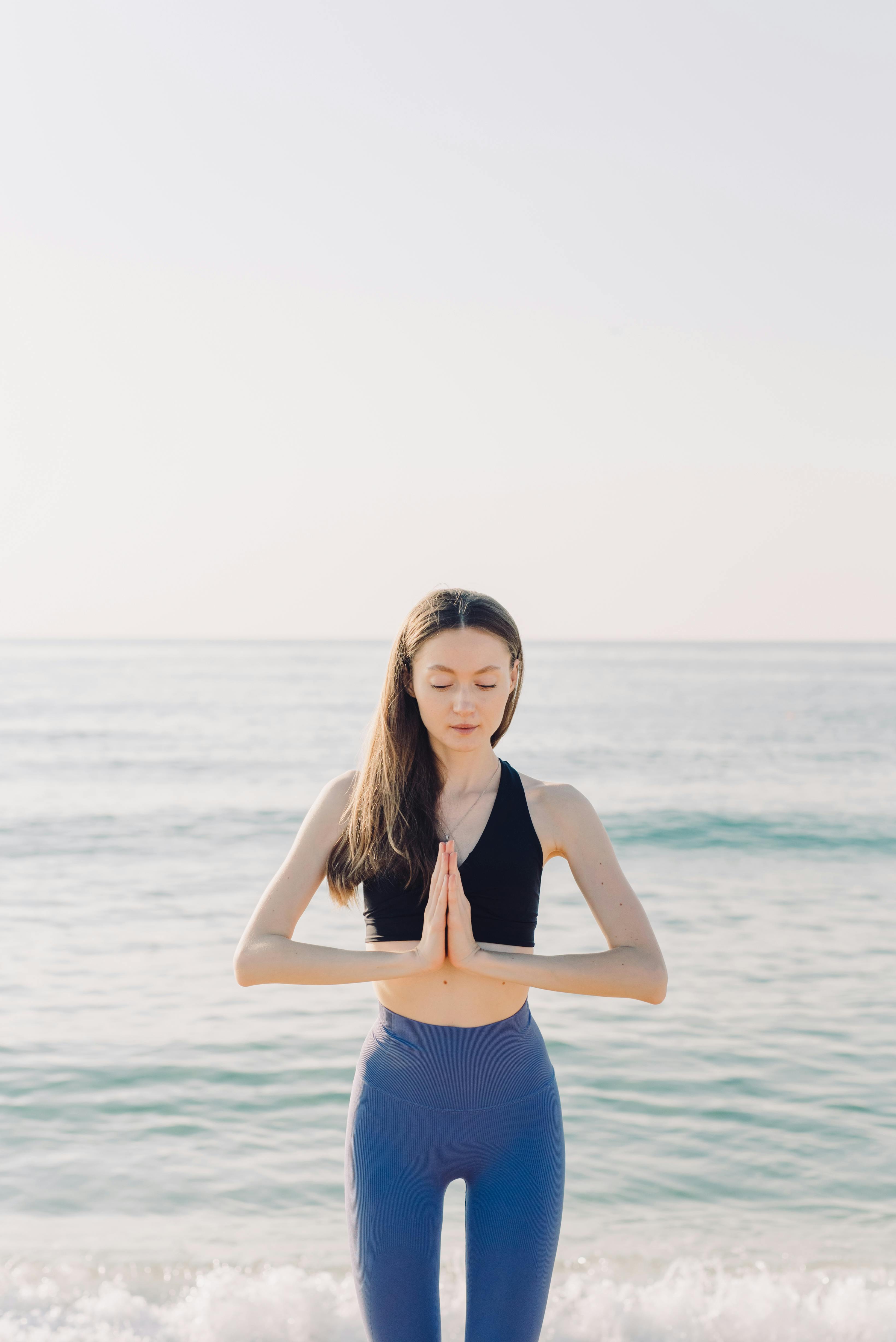 Young woman doing yoga in the beach wearing white clothes 5444617 Stock  Photo at Vecteezy