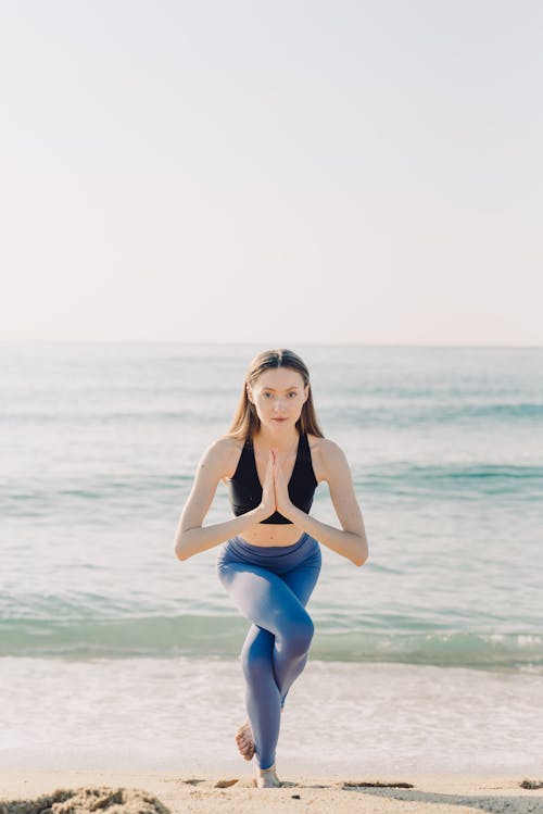 Woman in Gray Leggings and Black Sports Bra Doing Yoga on Yoga Mat