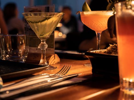 Close-up of cocktails on a dining table with ambient lighting in an Istanbul bar.