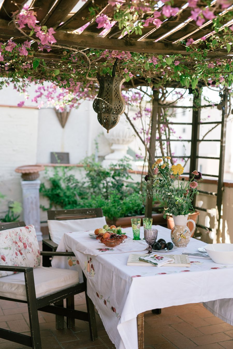 Sunny garden patio with a table setting on smart paving slabs