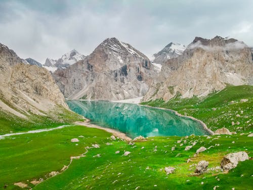 A Lake Surrounded With Grassland and Mountains