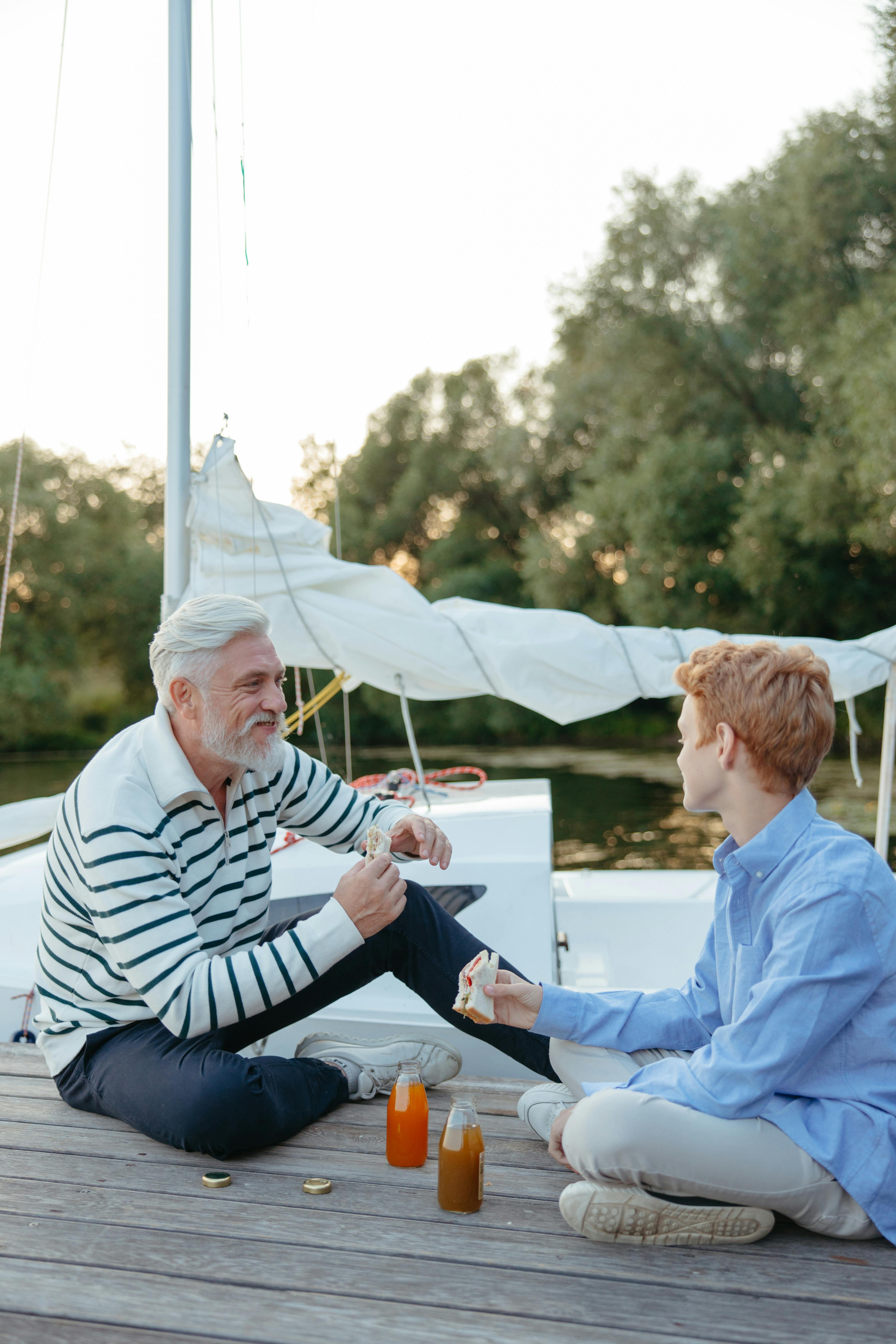Happy Senior Man and Son with Fishing Rods by Lake Stock Image