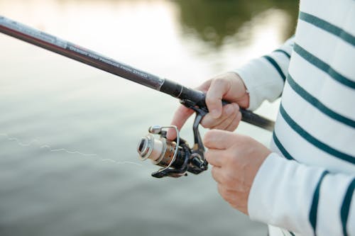 Close-Up Shot of a Person Holding a Fishing Rod