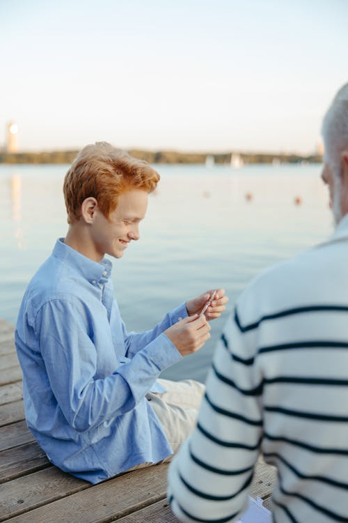 A Boy with Her Grandfather on the Dock