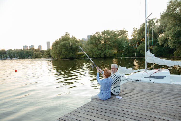 A Man Fishing With His Grandson