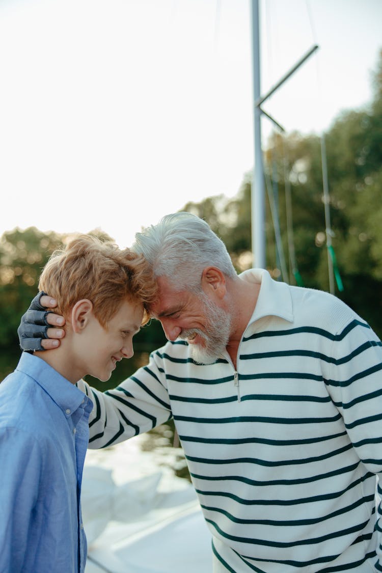 Grandpa And Grandson Leaning Their Foreheads With Each Other 