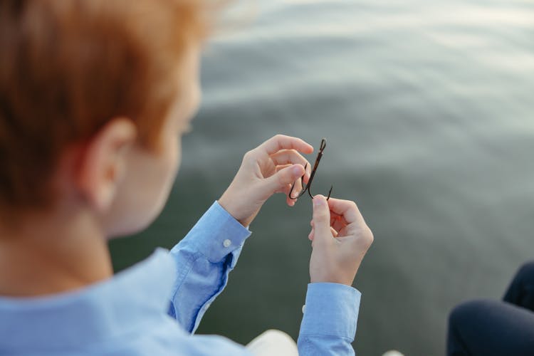 Young Man Holding A Sharp Fishing Hook