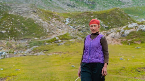 Middle-aged Woman standing on a Terrain 